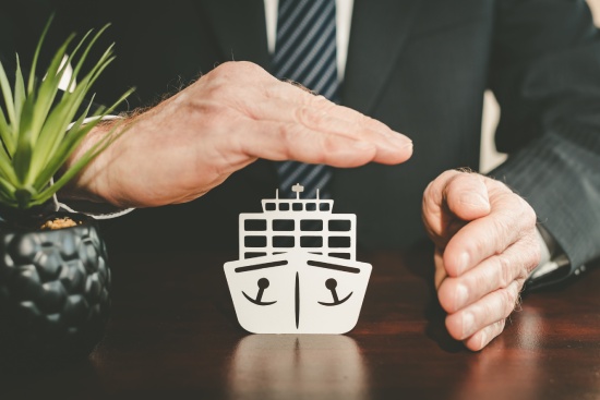 Insurer protecting a cargo ship with his hands