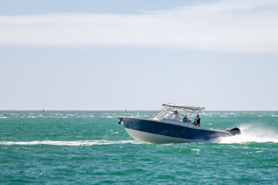 Saltwater fishing boat on a sunny summer day. People on recreational power boat cruising the Gulf of Mexico, Florida.