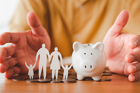 hands around piggy bank and family symbol. Coverage insurance life insurance. 